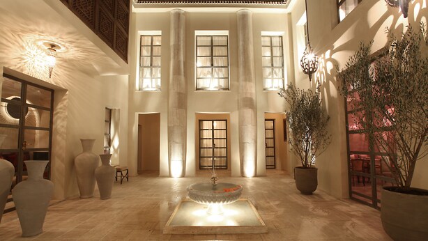 A spacious lobby with a central fountain, large windows, and tall columns. - Riad Joya (Marrakech)