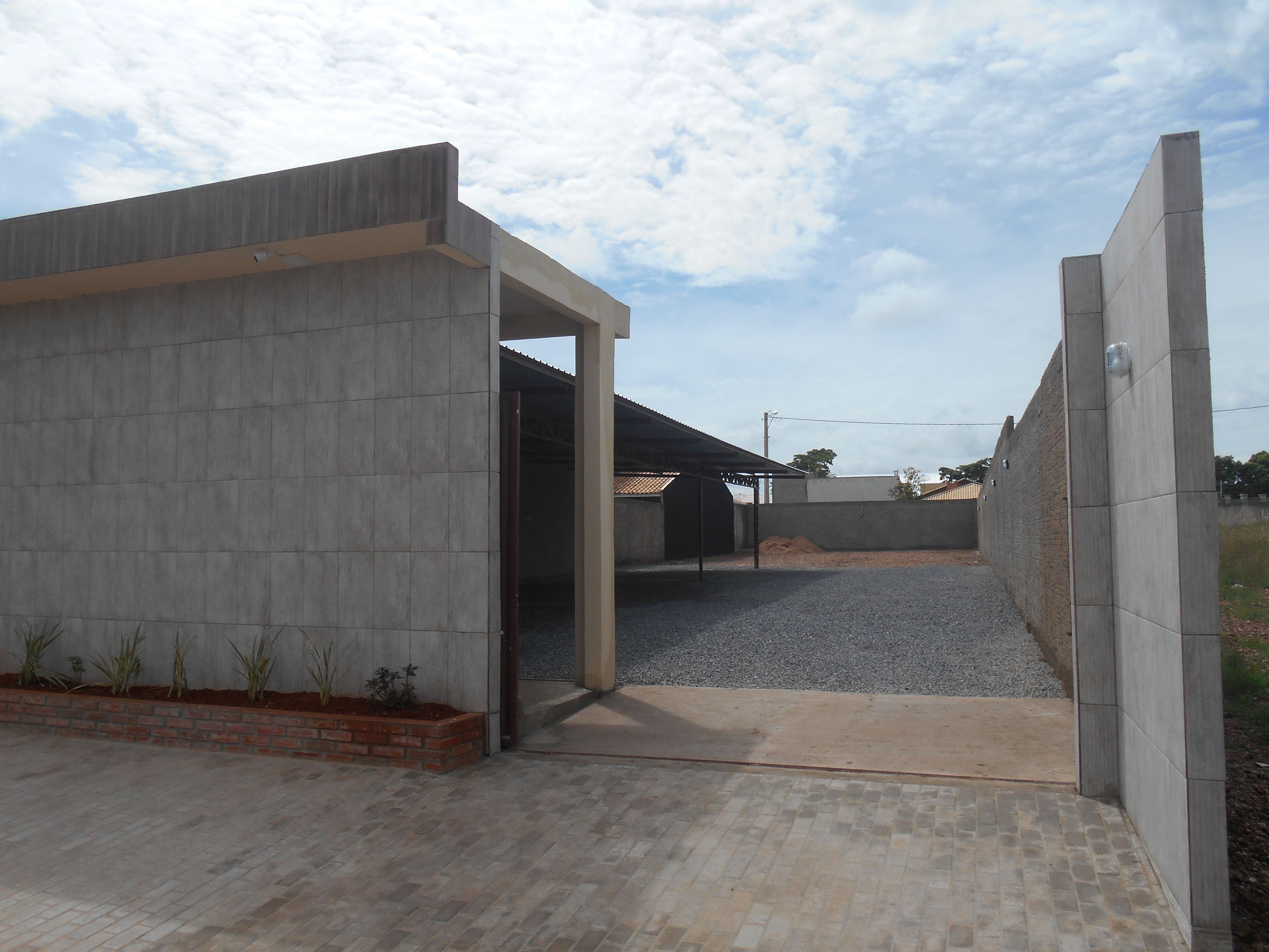 A modern building with a concrete facade and an open entrance.