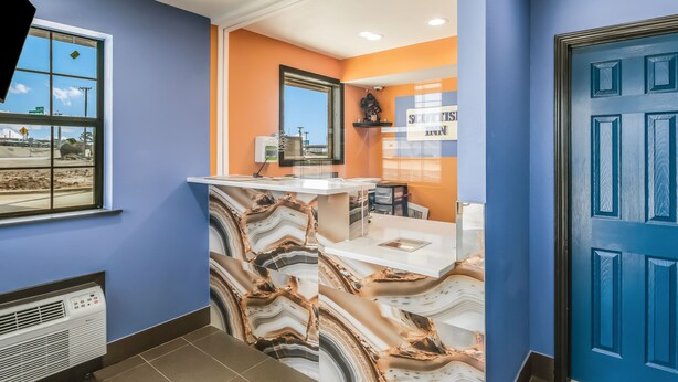 A modern bathroom with a marble backsplash, a sink, and a mirror.