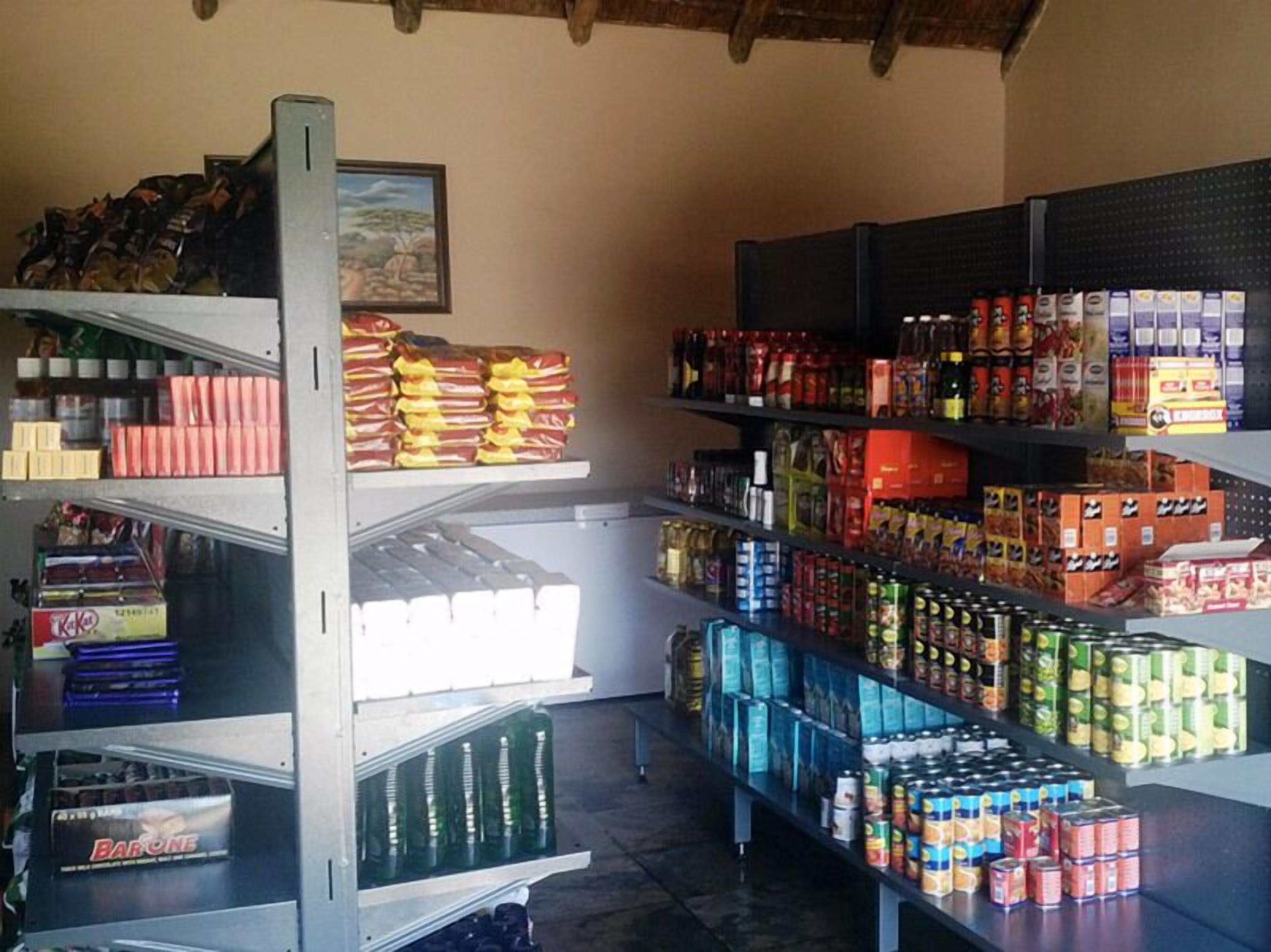 A grocery store with shelves stocked with various food items, including canned goods, snacks, and beverages.
