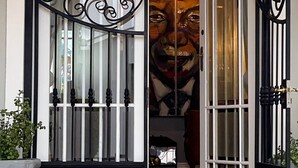 A grand entrance with a wrought iron gate, a decorative ceiling light, and a large mural on the wall. - Fleur du Soleil (Franschhoek)