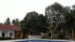 A swimming pool with a sign reading "Welcome to Celvis." - Celvis Vacation Cottages (Panglao)