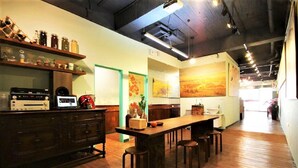 Un restaurante acogedor con mobiliario de madera, una zona de bar y obras de arte en las paredes.