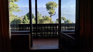 A room with a view of a mountainous landscape through large windows. - The Fort Resort (Baluwapati Deupur)
