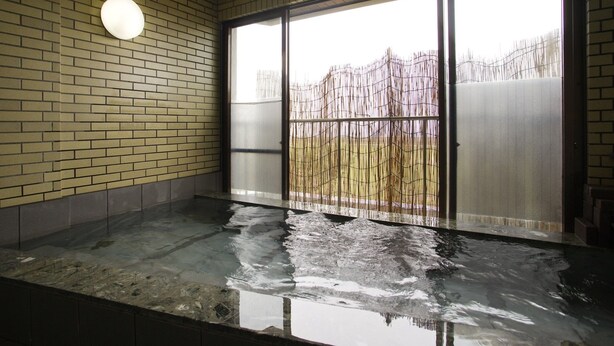 A room with a brick wall, a sliding glass door, and a round light fixture. - Resort Ryokan Yadokari (Echizen)