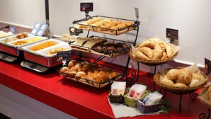 A buffet with various food items including bread, pastries, and other baked goods. - Hotel Guest1 Ueno Ekimae (Tokyo)
