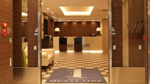 A hotel lobby with a checkered floor, a reception desk, and a sofa. - Hotel Guest1 Ueno Ekimae (Tokyo)