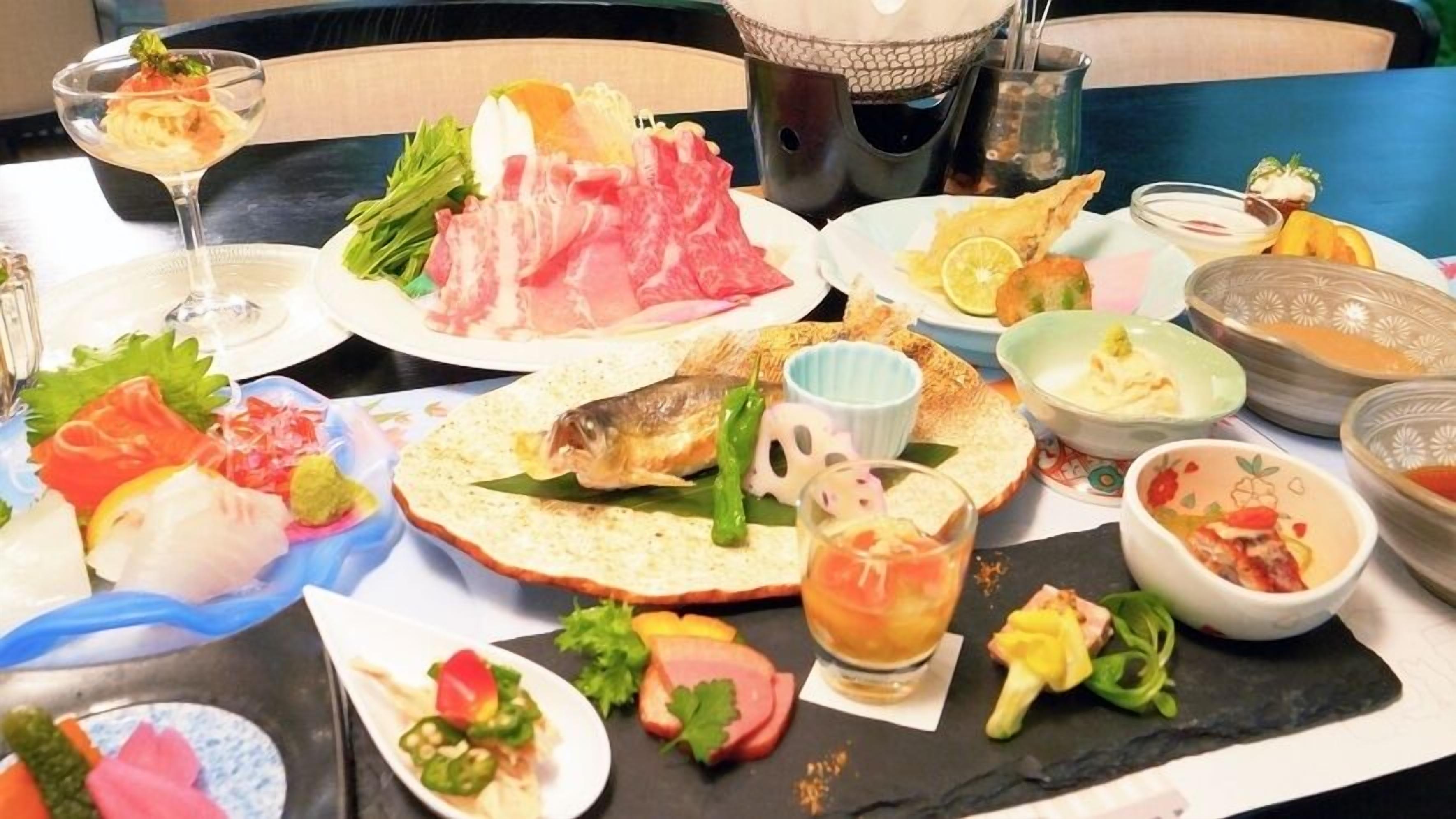 A variety of dishes including sashimi, fish, and vegetables on a table.