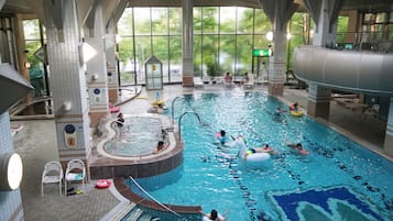 Relax by the pool surrounded by lush greenery.
