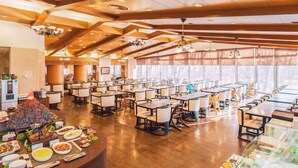 A spacious dining area with multiple tables and chairs, a central buffet with various dishes, and a modern ceiling design with recessed lighting. - Hotel Blancvert Nasu (Nasu)