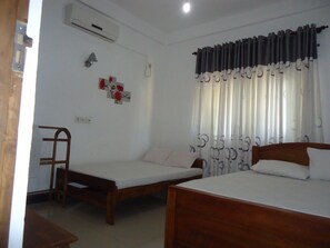 Family Room | Premium bedding, in-room safe, desk, iron/ironing board - Tree House Holiday Home (Anuradhapura)
