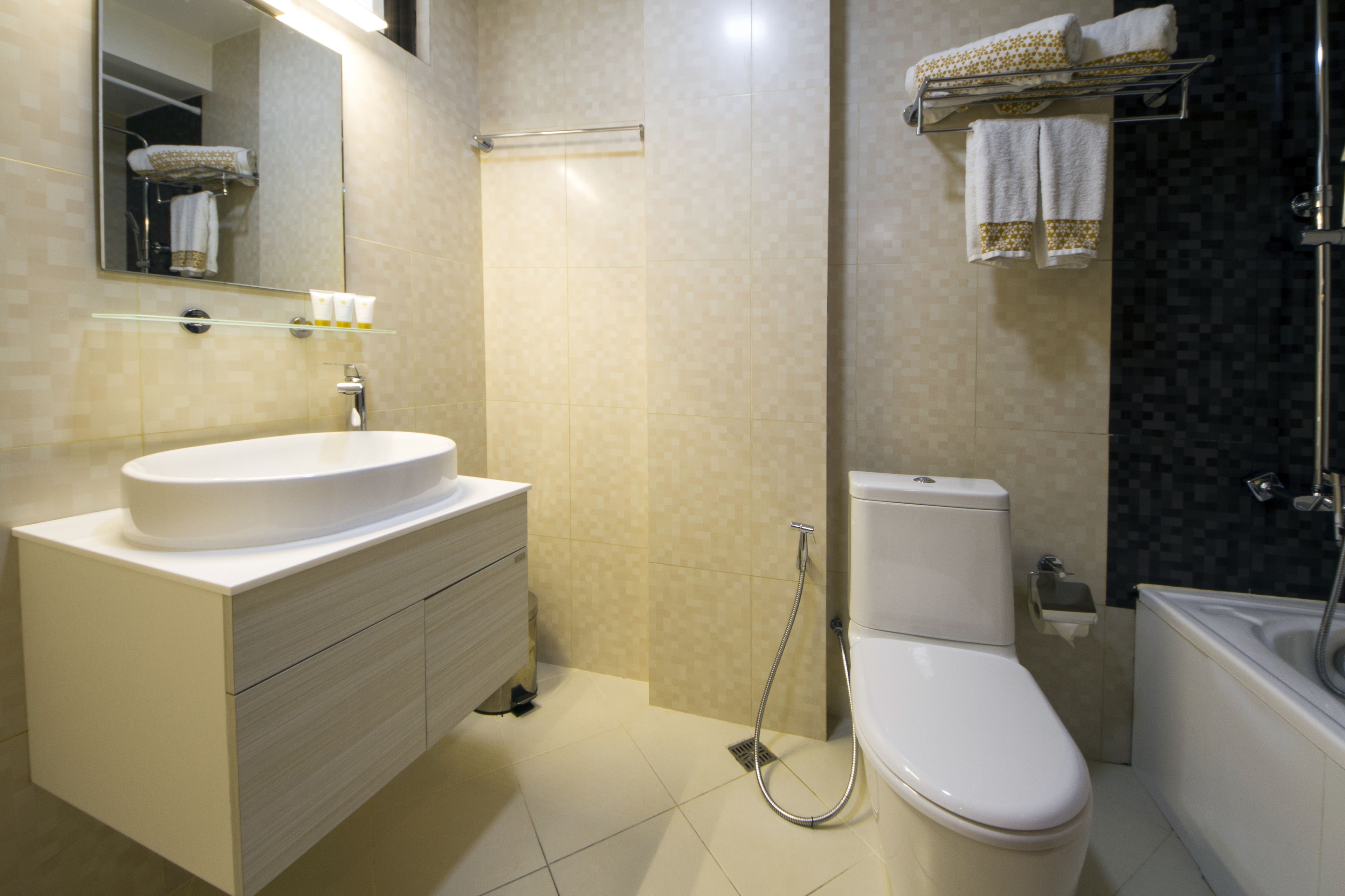 A modern bathroom with a white sink, toilet, and bathtub.