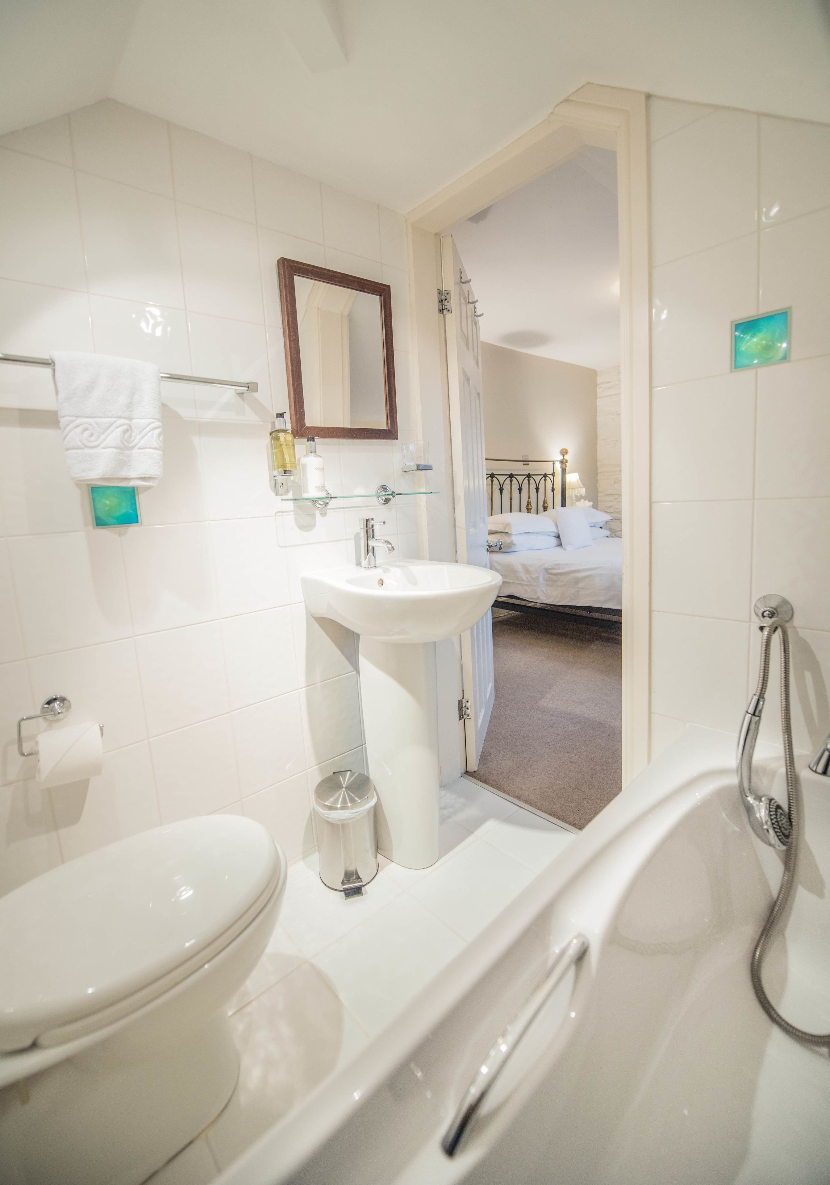 A modern bathroom with a toilet, sink, and bathtub.