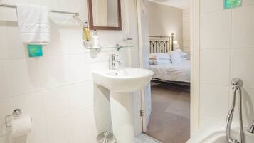 A modern bathroom with a toilet, sink, and bathtub.