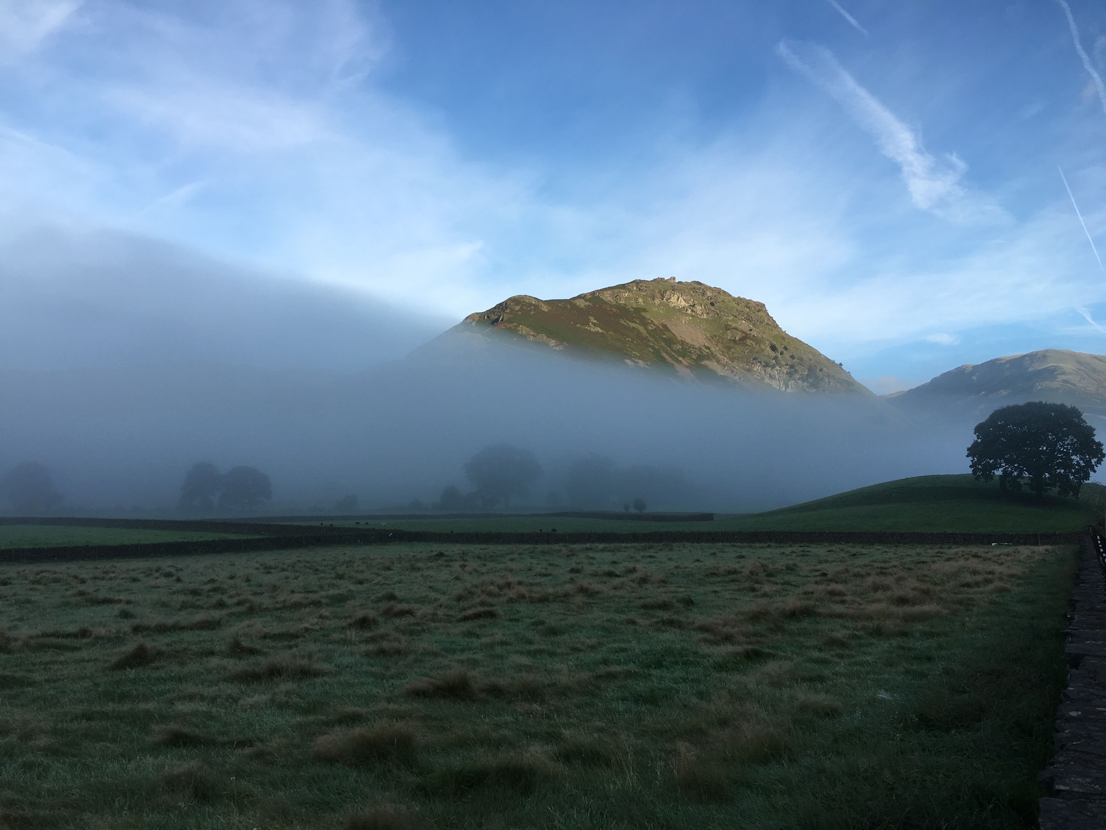 A misty mountain landscape with a clear sky.