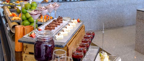 A buffet with various food items and drinks.