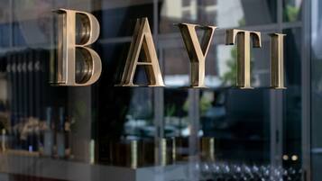 A glass facade with the name "BAYTI" in metallic letters.