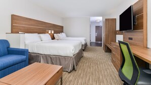 A hotel room with two beds, a desk, a chair, a TV, and a sofa. - Holiday Inn Express & Suites Ogallala by IHG (Ogallala)
