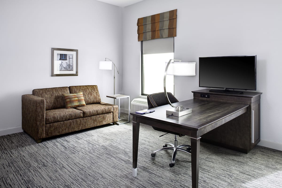 hypo-allergenic bedding, desk, laptop workspace, blackout curtains