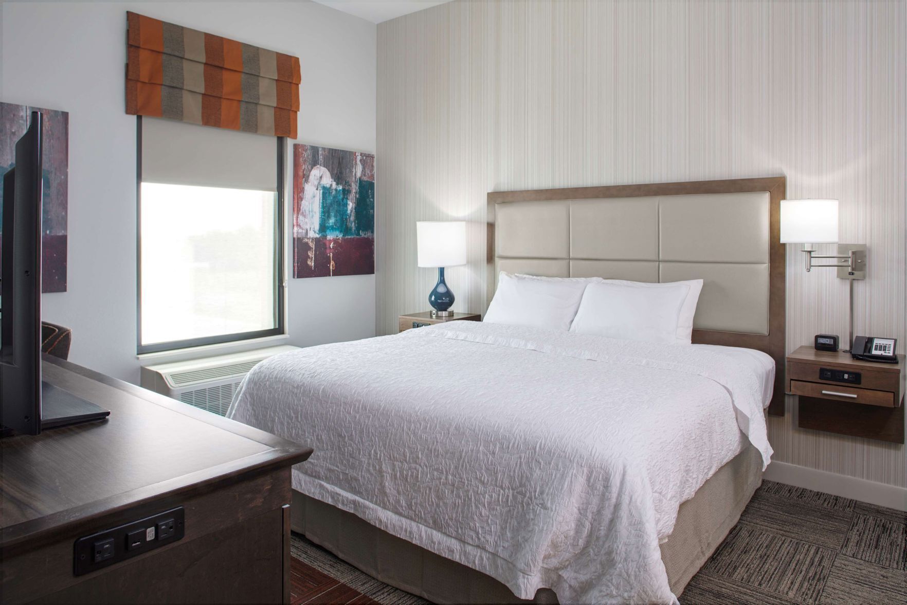 Hypo-allergenic bedding, desk, laptop workspace, blackout drapes