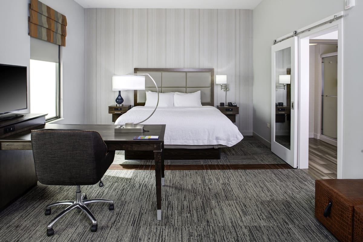 hypo-allergenic bedding, desk, laptop workspace, blackout curtains