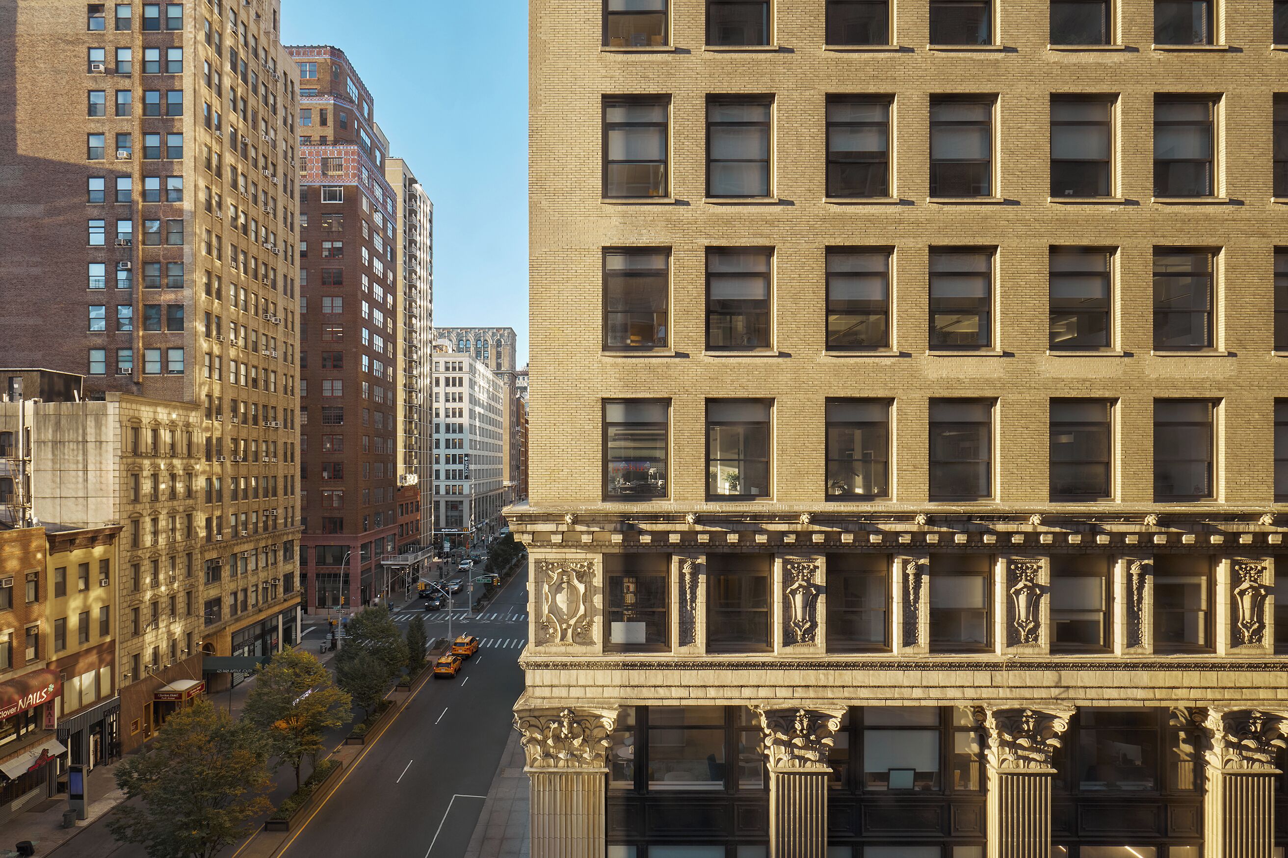 A multi-story building with a classic architectural style, featuring large windows and decorative elements.