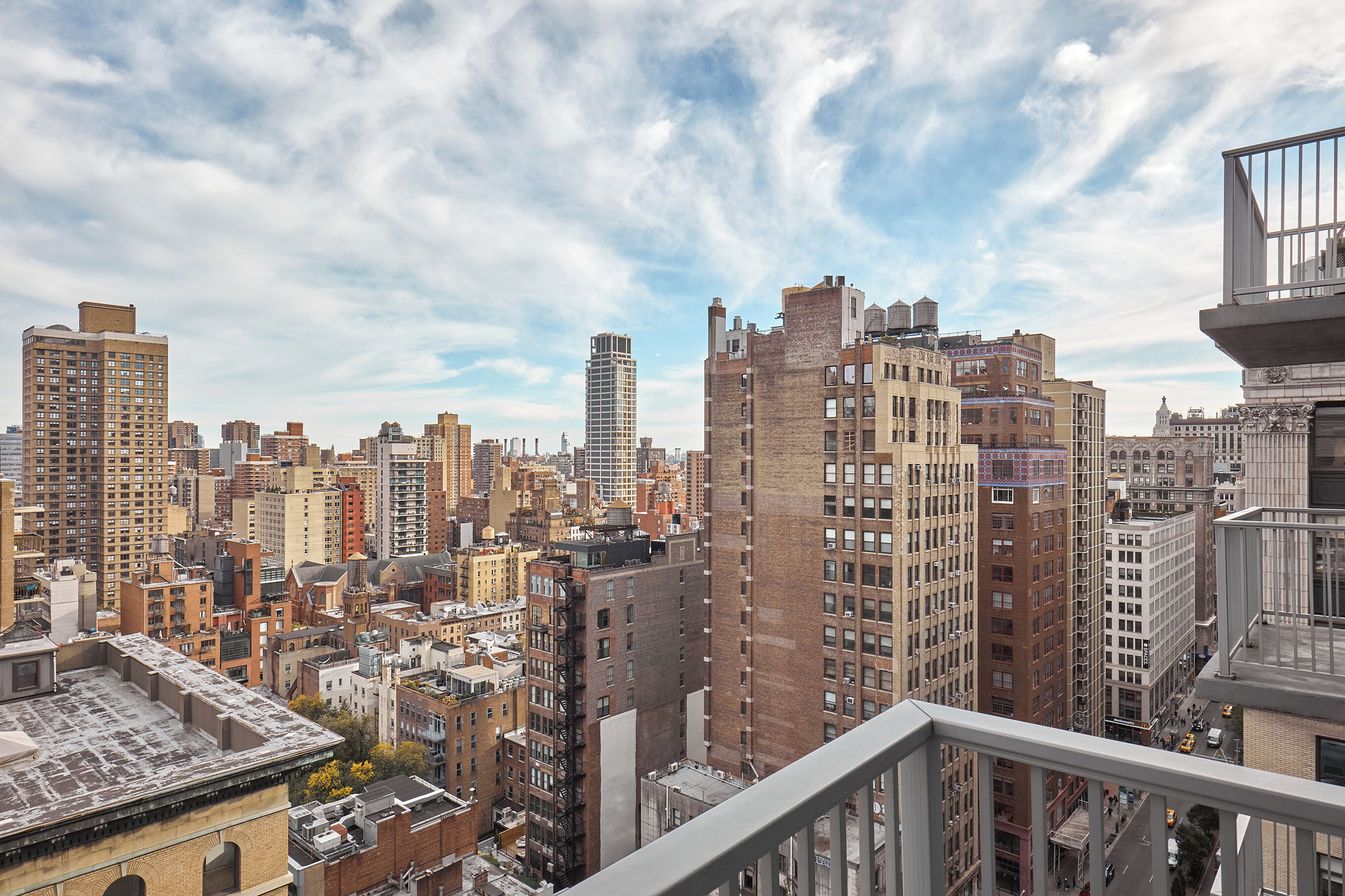 A high-rise cityscape with a variety of building styles and a clear sky.