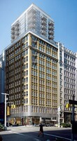 A multi-story building with a modern architectural design, featuring a mix of glass and brick facades.