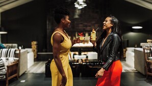 Two people in a modern interior with a high ceiling and exposed brick walls. - W Bellevue (Bellevue)