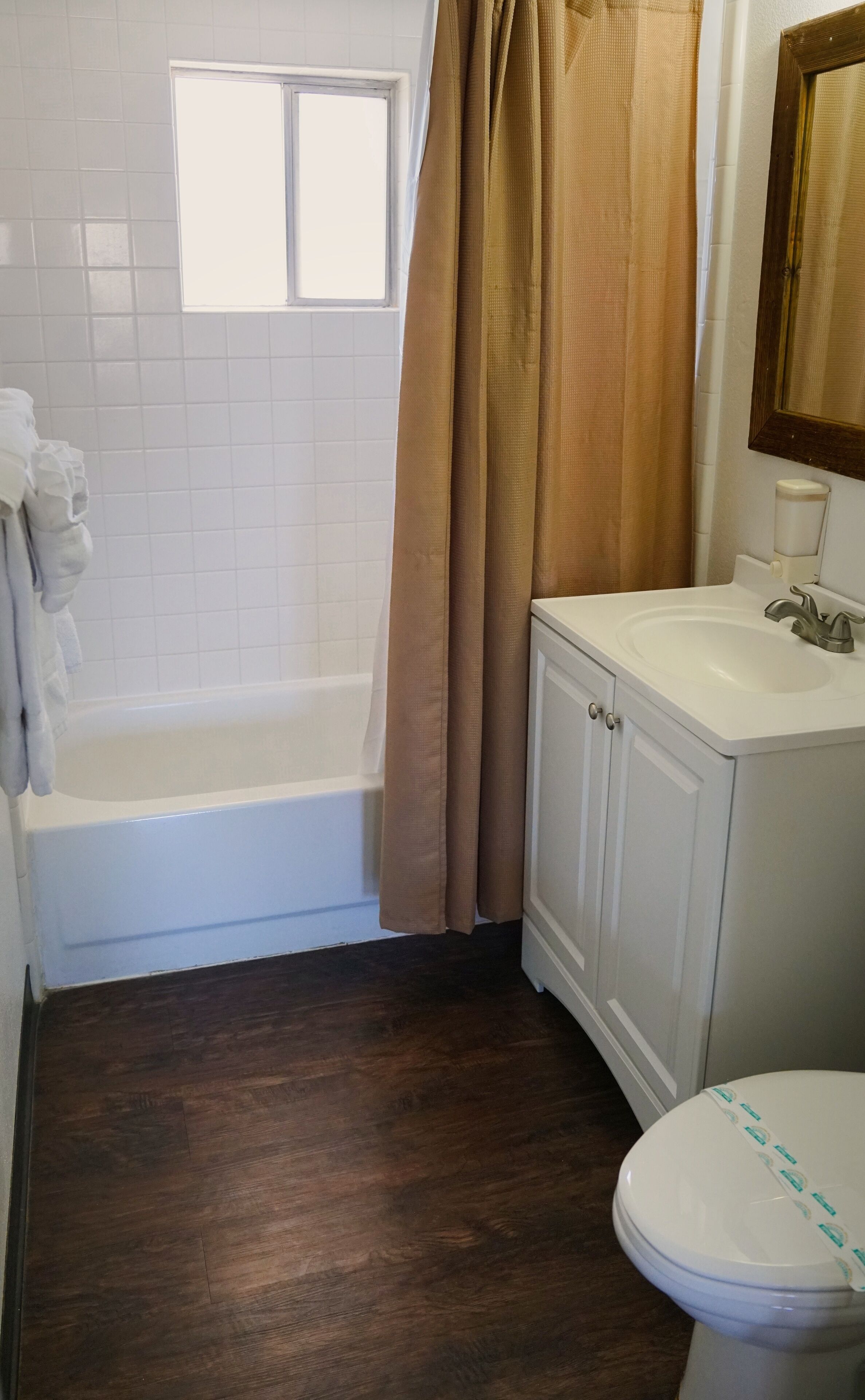 A bathroom with a bathtub, a toilet, and a sink.