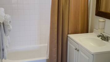 A bathroom with a bathtub, a toilet, and a sink.