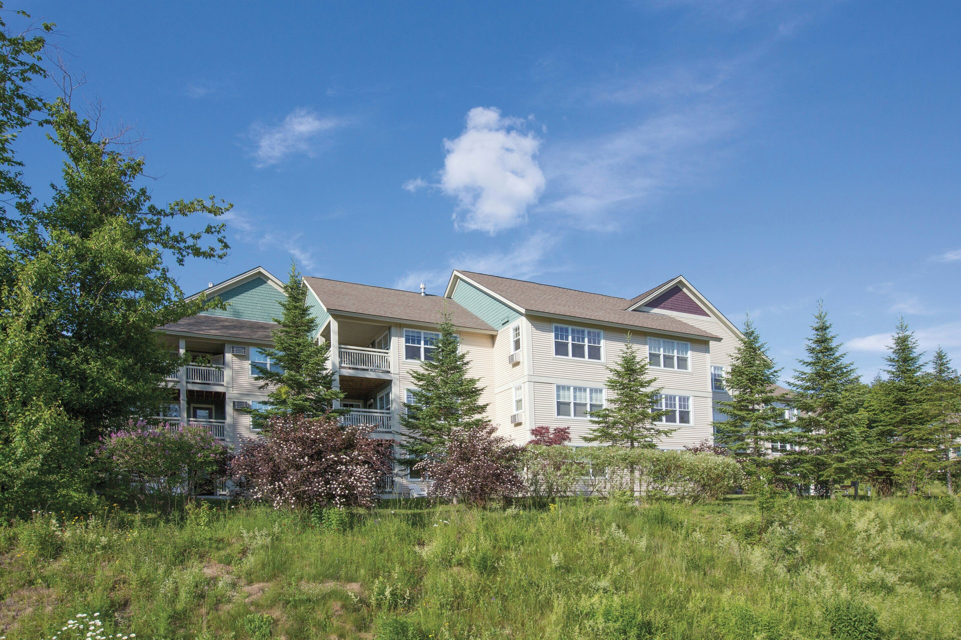 A multi-story residential building with a balcony on the second floor.