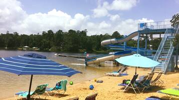 Relax and play in our beachside recreational area, featuring a water slide and lounge chairs.