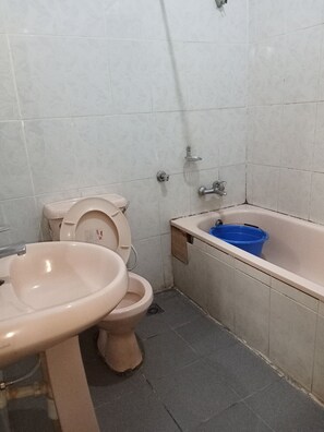 A bathroom with a toilet, sink, and bathtub. - Dreamland Suites (Abuja)