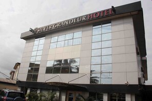 A hotel building with a modern facade, large windows, and a sign that reads "Silver Grandeur Hotel". - Silver Grandeur Hotel (Lagos)