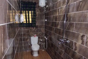 A bathroom with a toilet, a shower, and a towel rack. - Blue Seasons Hotel & Suites (Lagos)