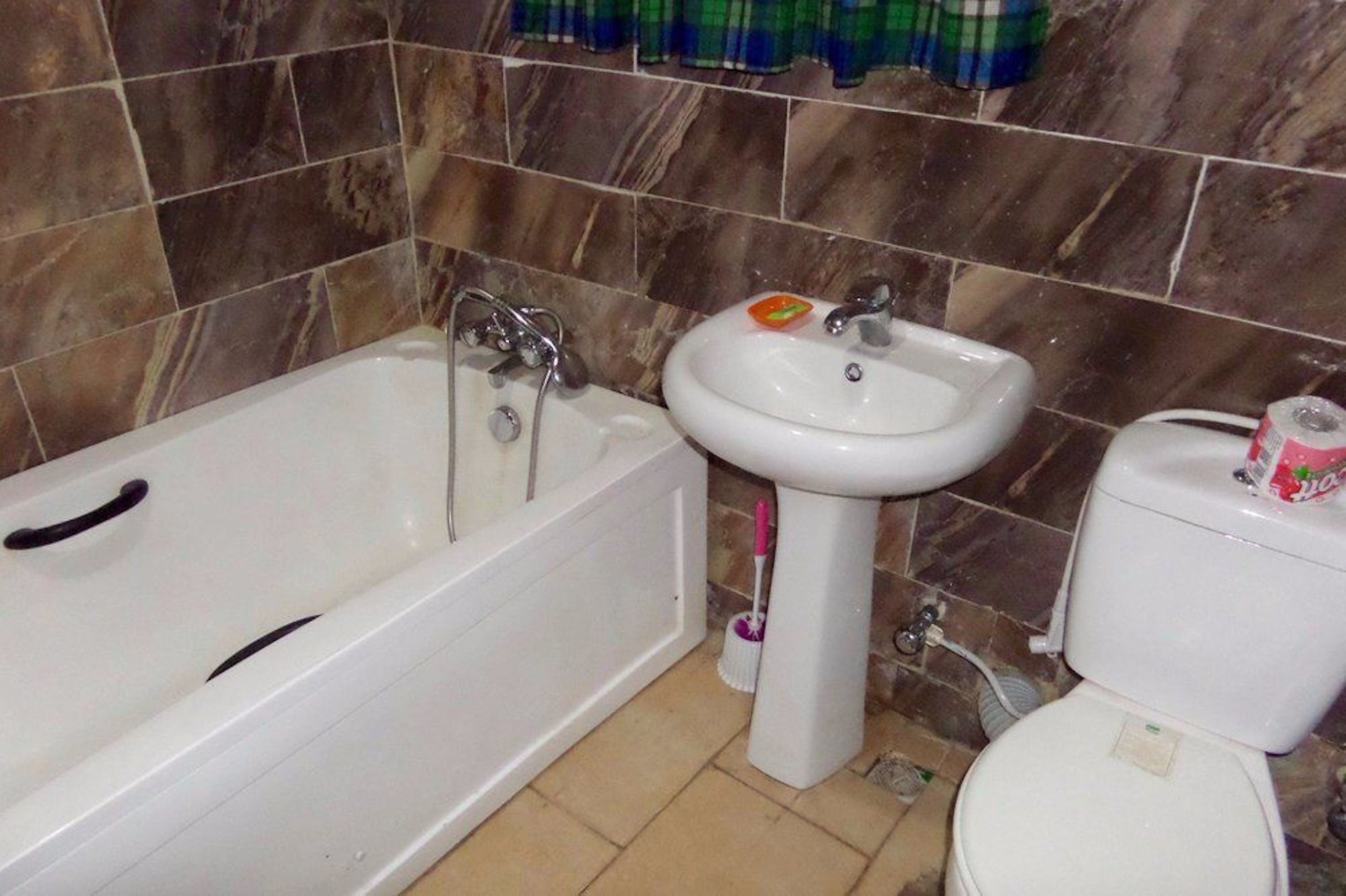 A bathroom with a bathtub, sink, and toilet.