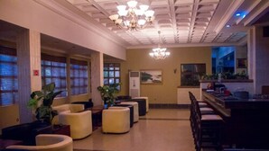 A hotel lobby with a chandelier, seating area, and a reception desk. - Dees Hotels, Apartments and Suites (Lagos)