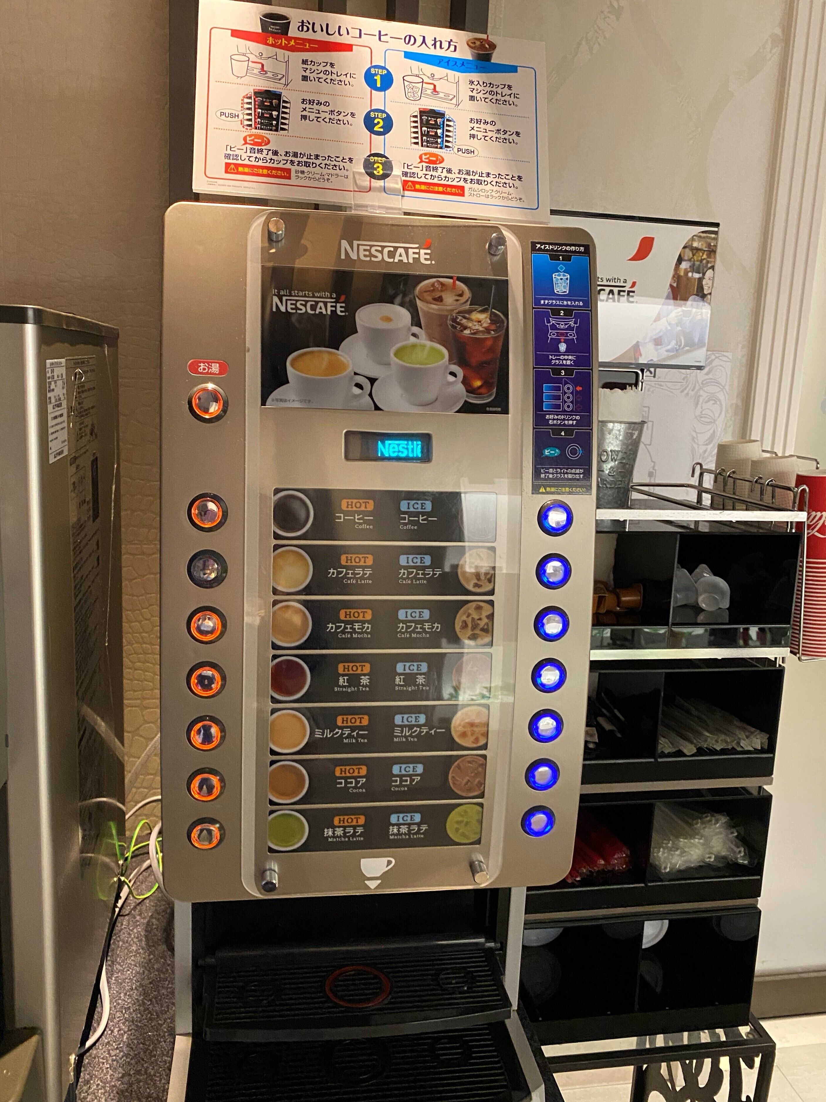 A Nescafe coffee machine with multiple drink options and a digital display.