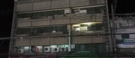 A multi-story building with a sign for 'WREGENT PLAZA HOTEL'.
