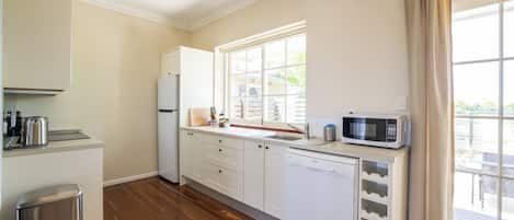 Courtyard Garden Apartment (Minimum Age 18) | Private kitchen | Full-size fridge, microwave, oven, stovetop