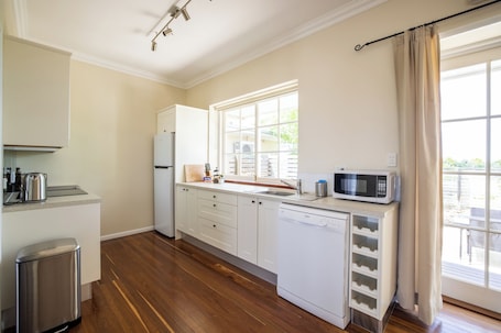 Courtyard Garden Apartment (Minimum Age 18) | Private kitchen | Full-size fridge, microwave, oven, stovetop