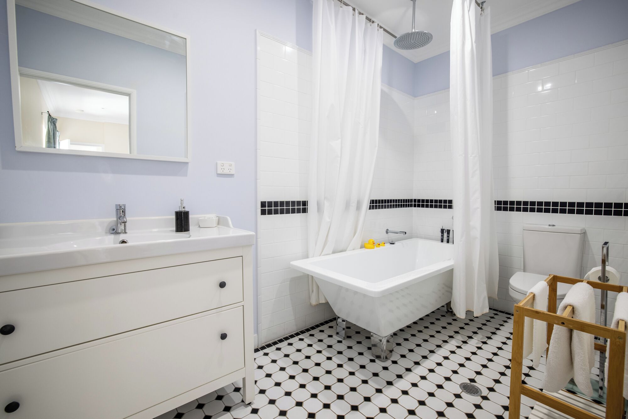 A bathroom with a white sink, a bathtub, and a toilet.