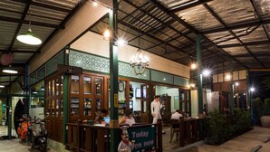 A restaurant with a green and brown exterior, a sign reading "Today Even Now", and a person in a chef costume outside. - Sunday J Resort & Restaurant (Chonburi)