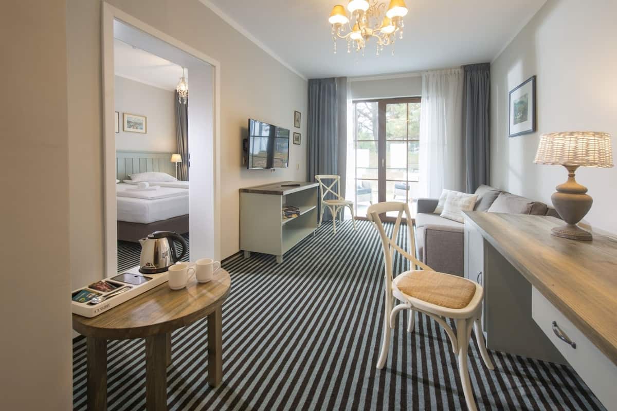 Exclusive Apartment | Living area | Flat-screen TV, foosball, table tennis, books