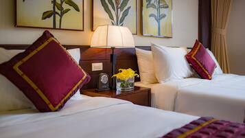 Deluxe Triple Room | Minibar, in-room safe, desk, blackout drapes