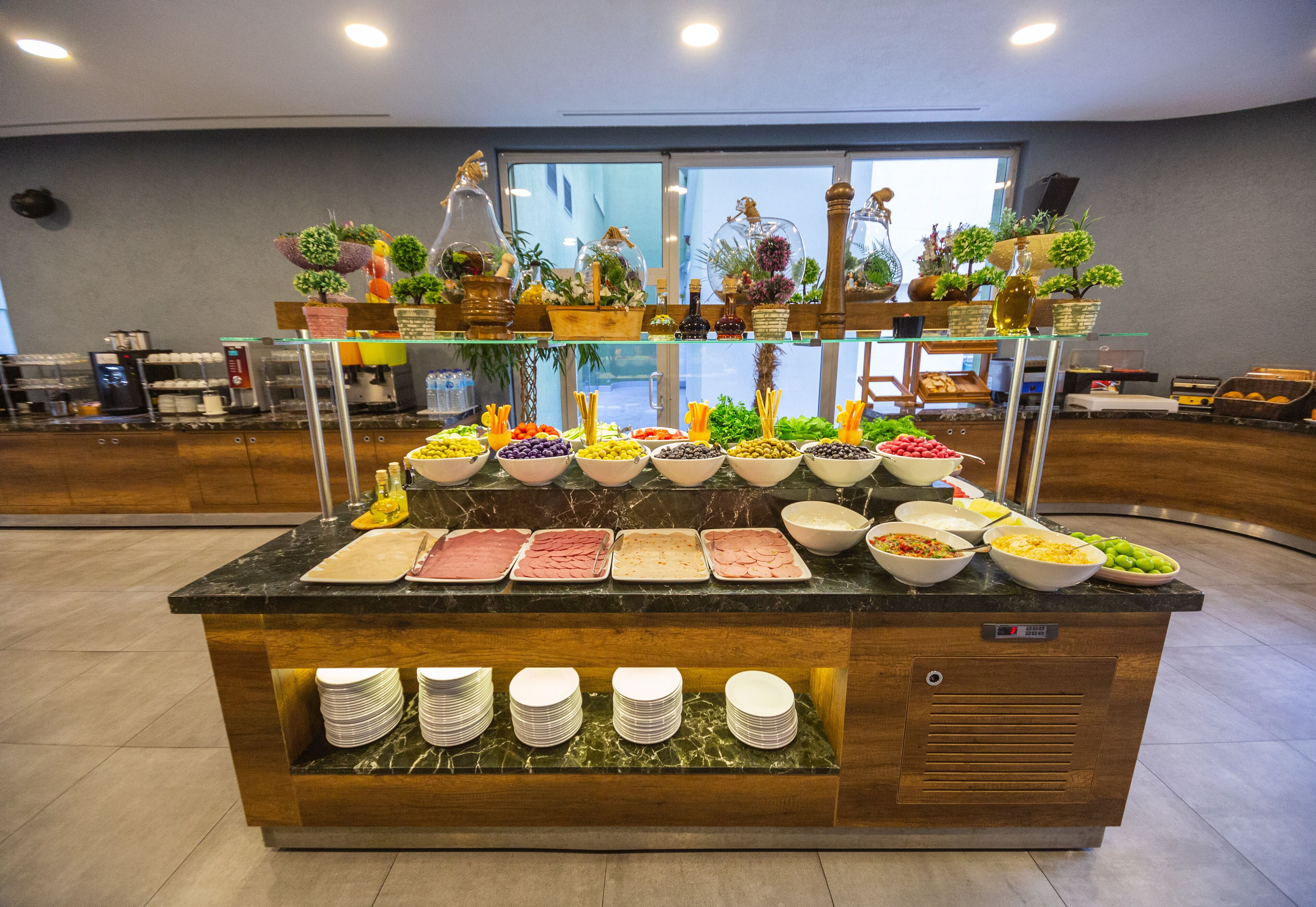 A buffet with various food options and a coffee station.