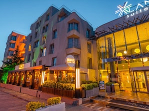 A hotel with a modern design, featuring a prominent sign for 'LAN SUITES' and a 'SOCIAL PILATE' facility.