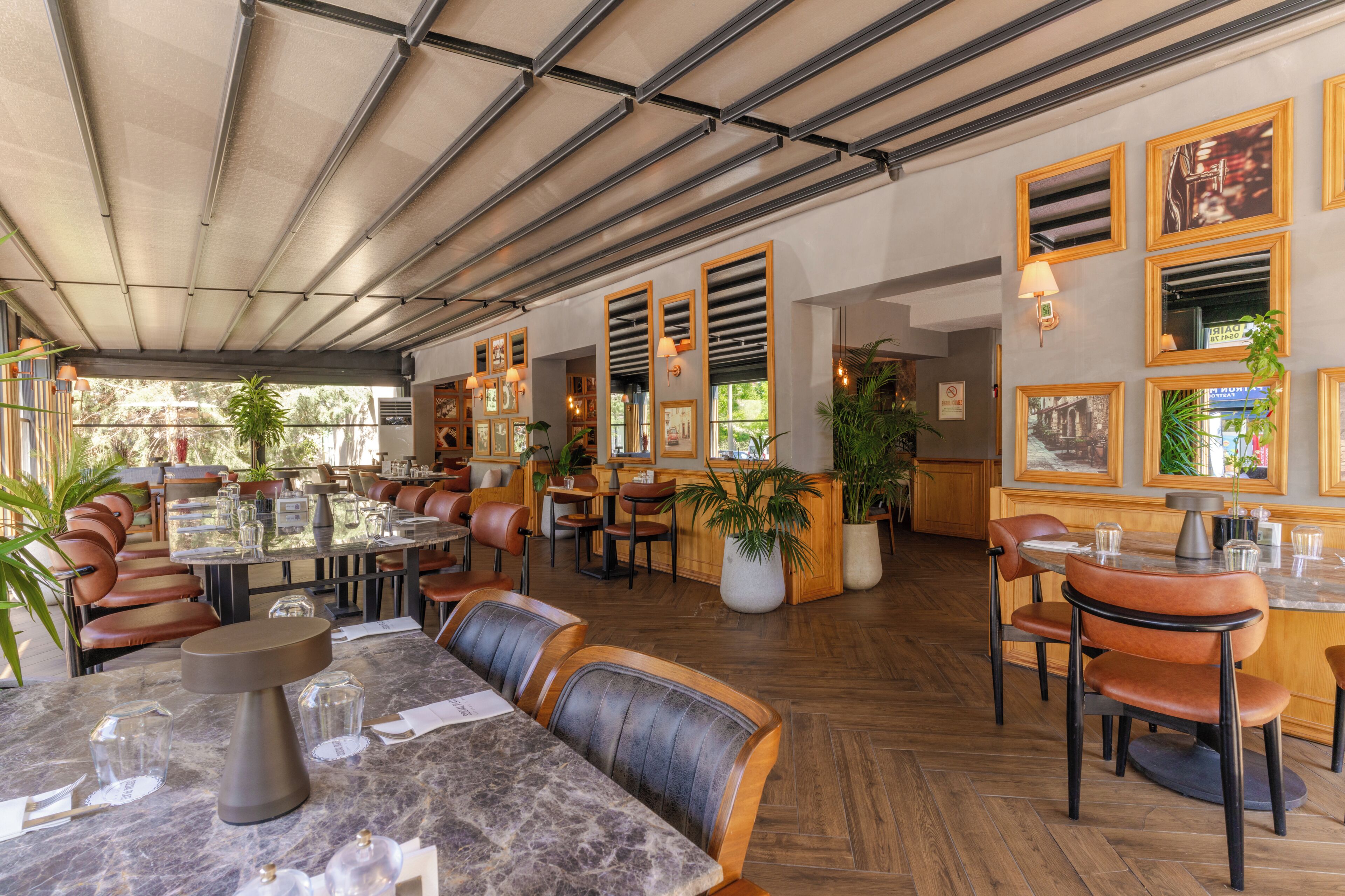A restaurant with indoor seating, a bar area, and a ceiling with a grid pattern.