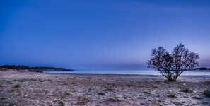 On the beach, white sand, sun loungers, beach umbrellas
